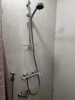 a shower with a shower head in a bathroom at Апартамент Миели in Sofia