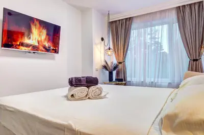 a bedroom with a bed with a fireplace at Boutique Apartment DOLCHE VITA in Smolyan