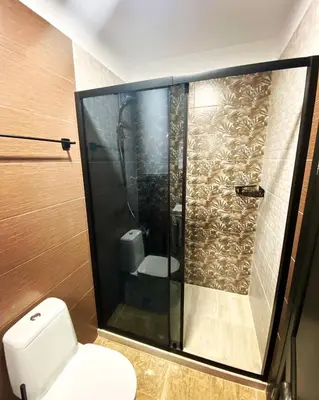 a bathroom with a shower and a toilet in it at Boutique Apartment DOLCHE VITA in Smolyan