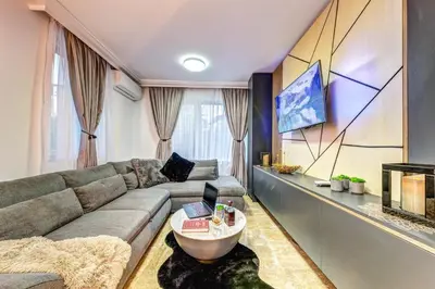 a living room with a couch and a table at Boutique Apartment DOLCHE VITA in Smolyan