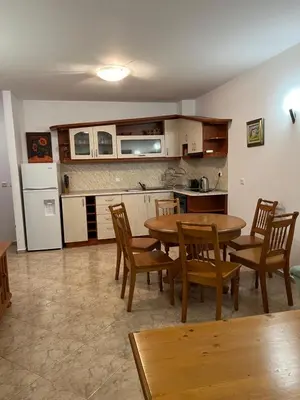 a kitchen with a table and chairs in a room at Скиелит 3 in Pamporovo