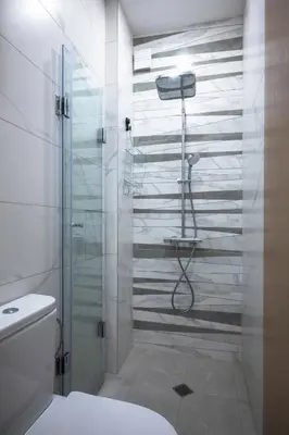 a bathroom with a shower with a glass door at Stylish CityHub Retreat in Sofia Center by Flat Mаnager in Sofia