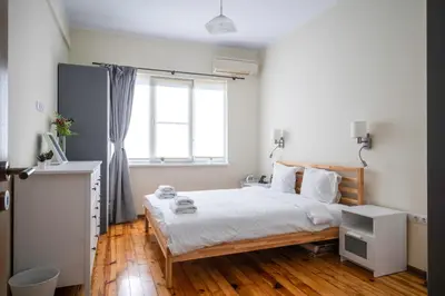 a bedroom with a bed and a window at Stylish CityHub Retreat in Sofia Center by Flat Mаnager in Sofia