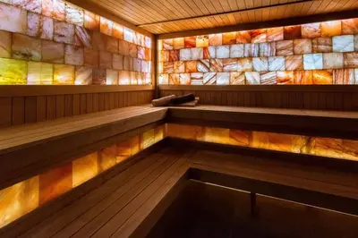 an empty sauna with a colorful tile wall at Мия 2 Deluxe Royal Spa in Velingrad