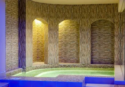 a room with two arched windows in a brick wall at Мия 2 Deluxe Royal Spa in Velingrad