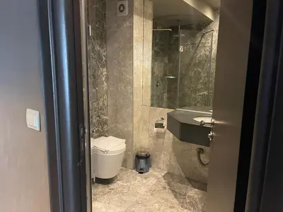 a bathroom with a toilet and a sink and a mirror at Мия 2 Deluxe Royal Spa in Velingrad