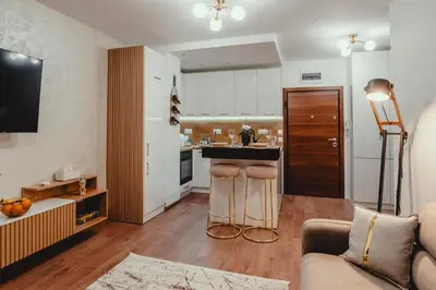 a living room with a couch and a kitchen at Elegant Living Apartment 2 in Sofia