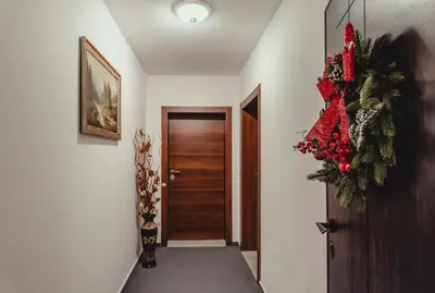 a hallway with a door and a christmas wreath at Elegant Living Apartment 2 in Sofia