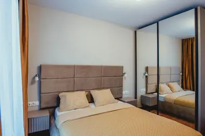 a bedroom with two beds and a mirror at Elegant Living Apartment 1 in Sofia