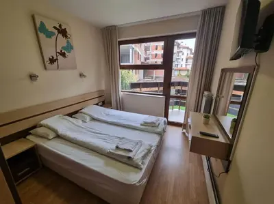 a small room with a bed and a window at Domo 12 Belmont, Bansko in Bansko