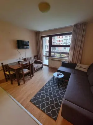a living room with a couch and a table at Domo 12 Belmont, Bansko in Bansko