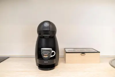 a coffee maker sitting on a table next to a box at Victor Hugo Studio in Sofia