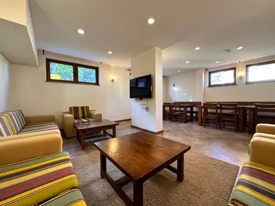 a living room with a couch and a table and a dining room at St Ivan Rilski SPA Studio in Bansko
