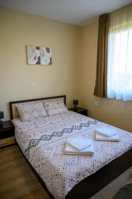 a bedroom with a bed with two towels on it at Rila Hills in Samokov