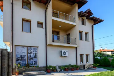 a white building with plants in front of it at Rila Hills in Samokov