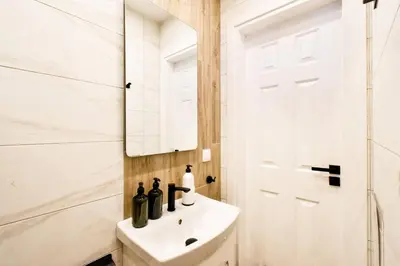 a white bathroom with a sink and a mirror at Skyline View - Very Central - Metro - Washer&Dryer in Sofia