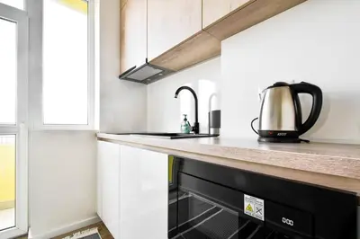 a small kitchen with a black dishwasher at Skyline View - Very Central - Metro - Washer&Dryer in Sofia
