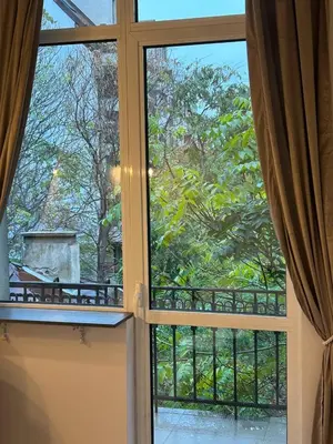 an open window with a view of a garden at Pirotska Modern Room in Sofia