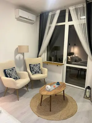 a living room with two chairs and a coffee table at Pirotska Modern Room in Sofia