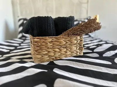 a basket of yarn sitting on top of a bed at Pirostka Vintage Room in Sofia