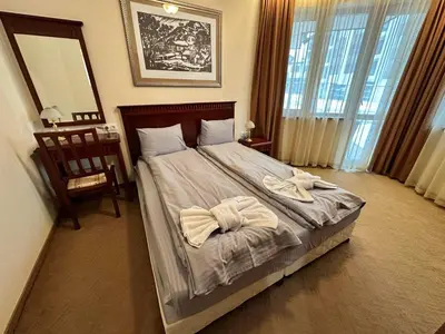 a bedroom with a bed with two towels on it at Luxury apartments in Downtown Residential Complex in Bansko