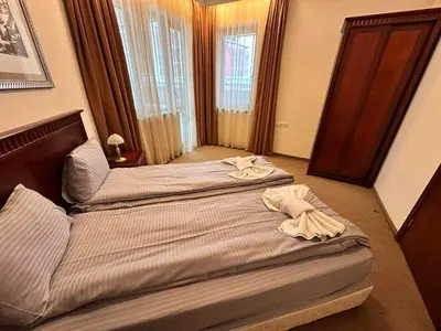 two beds in a hotel room with towels on them at Luxury apartments in Downtown Residential Complex in Bansko