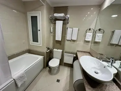 a bathroom with a tub and a toilet and a sink at Luxury apartments in Downtown Residential Complex in Bansko