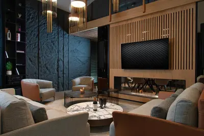 a lobby with couches and tables and a fireplace at Alpine Bell Villa in Banya