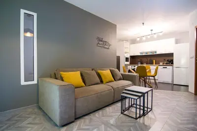 a living room with a couch and a table at Аpartment near Sofia airport in Sofia
