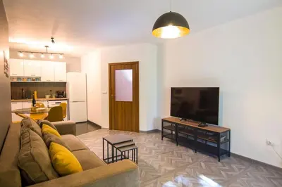 a living room with a couch and a flat screen tv at Аpartment near Sofia airport in Sofia