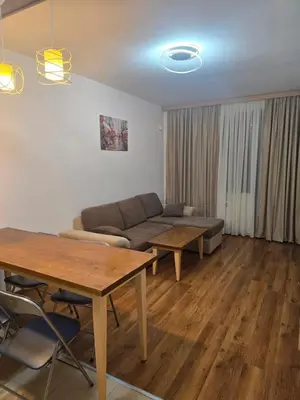 a living room with a couch and a table at Belvedere K203 in Bansko