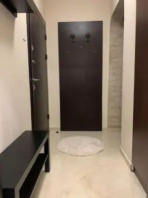 a bathroom with a black door and a white rug at Lena in Sofia