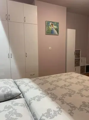 a bedroom with a bed and a cabinet at Lena in Sofia