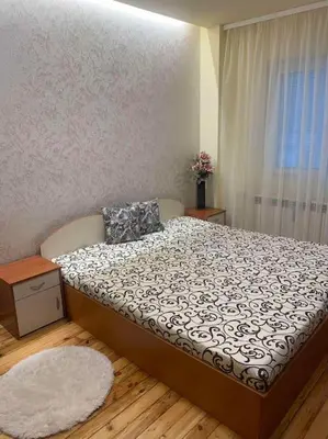 a bedroom with a bed with a pillow and a window at Lena in Sofia