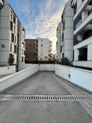 an empty parking lot in the middle of two buildings at Boston Cozy Elegant Family Apt w Parking Near NSA in Sofia