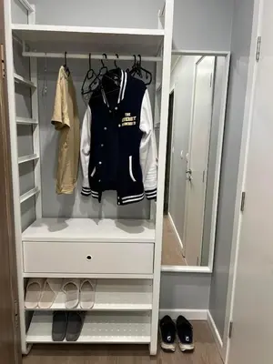 a walk in closet with a jacket and shoes at Boston Cozy Elegant Family Apt w Parking Near NSA in Sofia