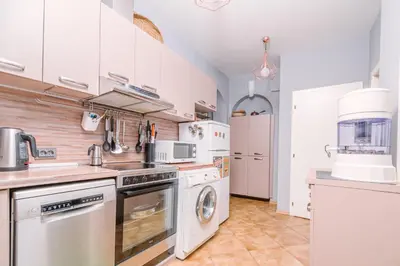 a large kitchen with white cabinets and appliances at Top Center, 3BDR, Heart of the city, FREE Secured Parking in Sofia