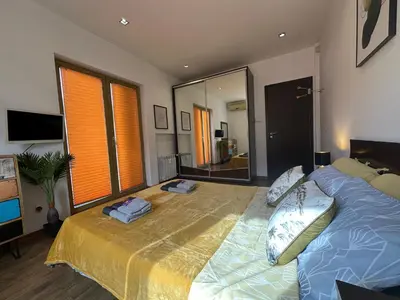 a bedroom with a large bed and a large mirror at Rakovski Residence in Sofia