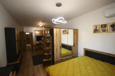 a bedroom with a yellow bed and a mirror at SOFIA CENTRAL LUXURY apartment 