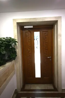 a wooden door in a building with a potted plant at SOFIA CENTRAL LUXURY apartment 