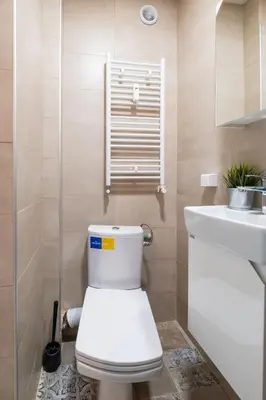 a bathroom with a toilet and a sink at Orange friendly apartment near Vitosha blvd in Sofia