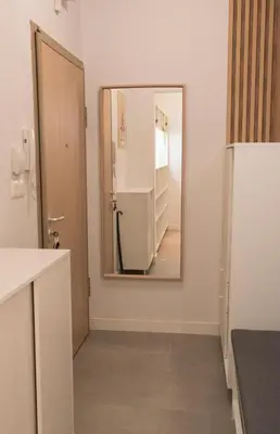 a kitchen with a mirror and a refrigerator at Top Center Designer Apartment in Sofia
