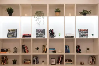 a book shelf filled with books and potted plants at Top Center Designer Apartment in Sofia