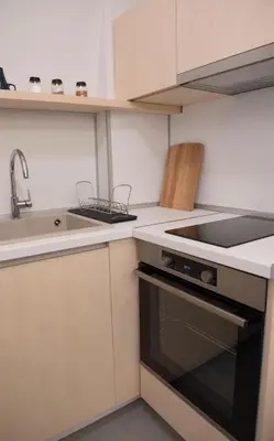 a small kitchen with a sink and a stove at Top Center Designer Apartment in Sofia