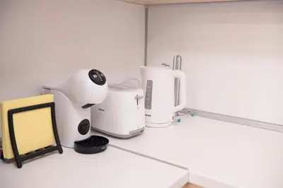 a kitchen counter with some appliances on a table at Top Center Designer Apartment in Sofia