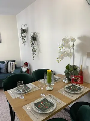 a wooden table with plates and glasses on it at Elizi winter apartments Pamporovo in Pamporovo