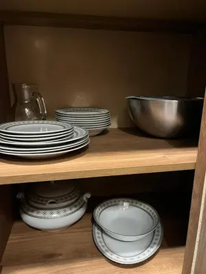 a shelf with plates and bowls and a bowl at Elizi winter apartments Pamporovo in Pamporovo