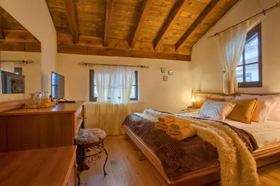 a bedroom with a bed and a dresser and a desk at 8BD Retreat in Bansko Comfort & Mountain Charm by Flat Mаnager in Bansko