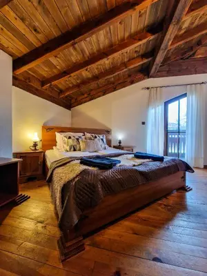 a bedroom with a large bed with a wooden ceiling at 8BD Retreat in Bansko Comfort & Mountain Charm by Flat Mаnager in Bansko