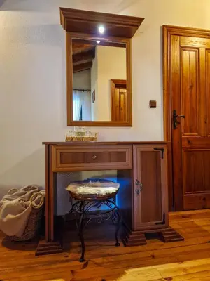 a bathroom with a vanity with a mirror and a stool at 8BD Retreat in Bansko Comfort & Mountain Charm by Flat Mаnager in Bansko
